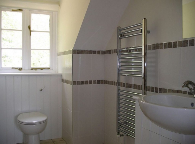 Cottage bathroom with silver towel rail